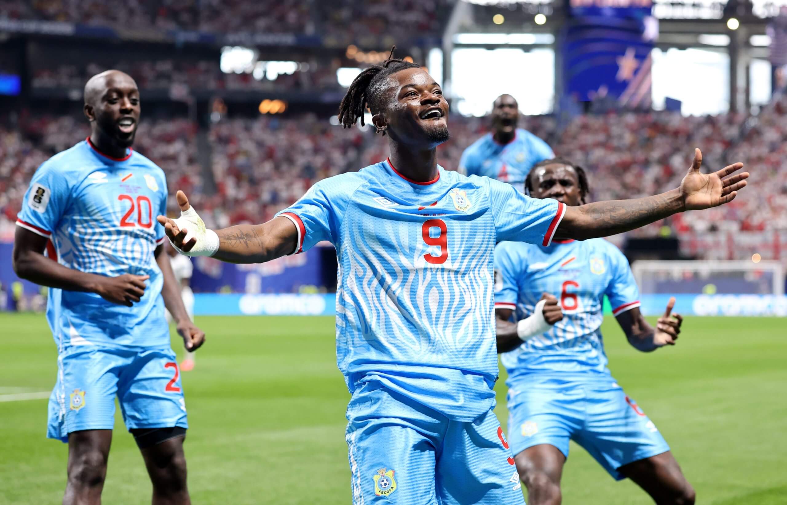 Brian Cipenga outstretches his arms as he celebrates scoring DR Congo's goal against England