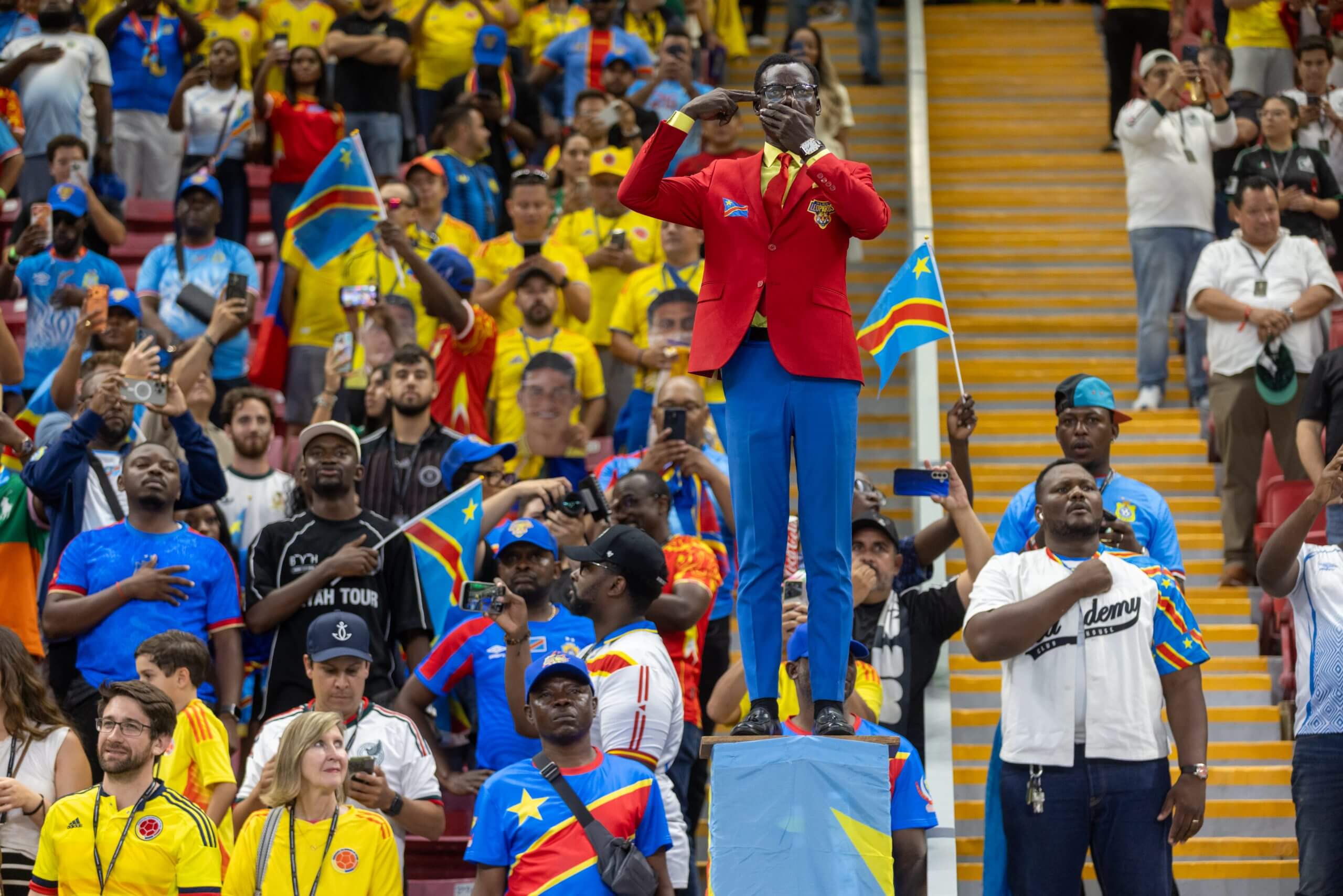 DR Congo supporter Michel Kuka Mboladinga performs his statue routine in the stand against Colombia