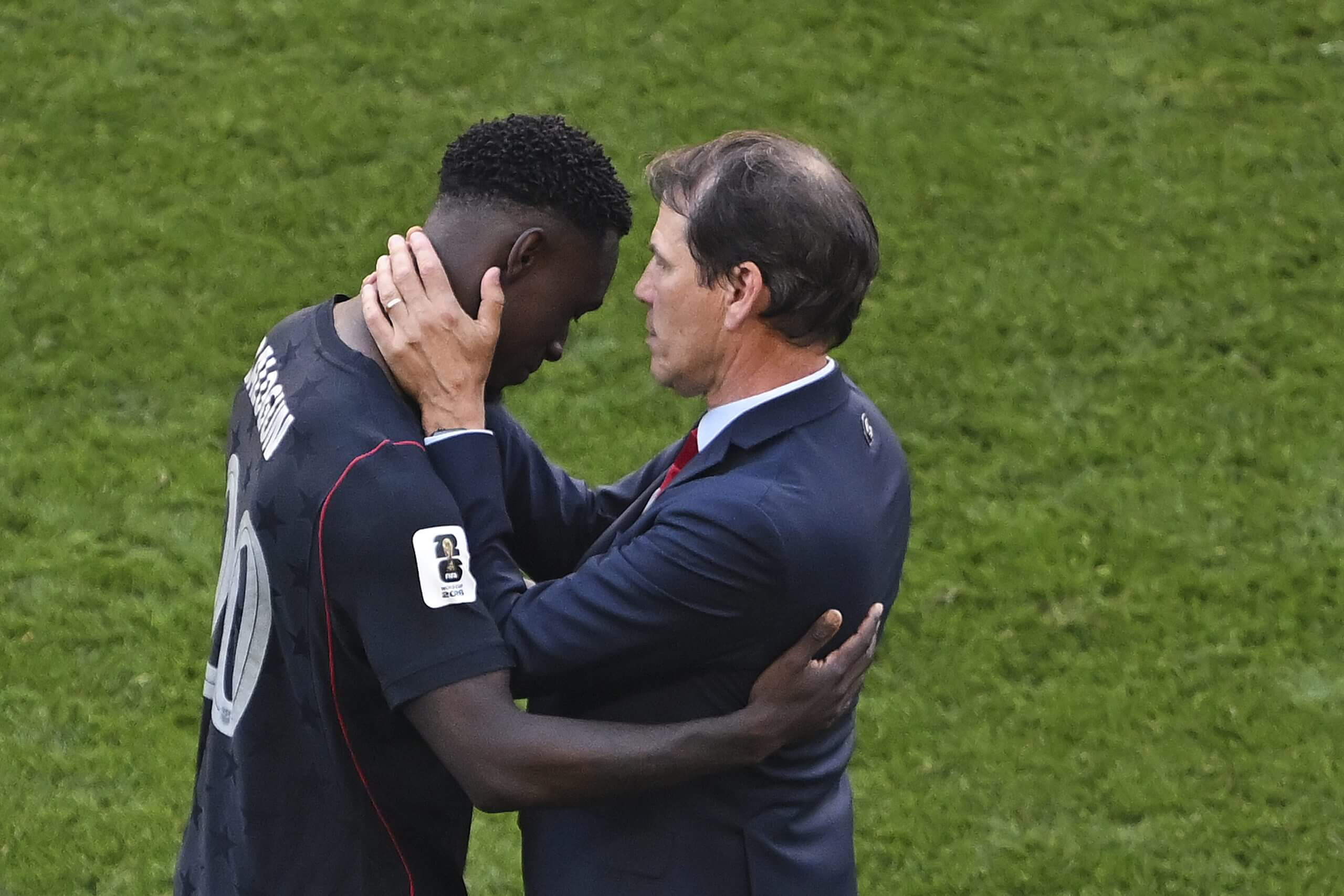 Folarin Balogun is consoled by Belgium head coach Rudi Garcia