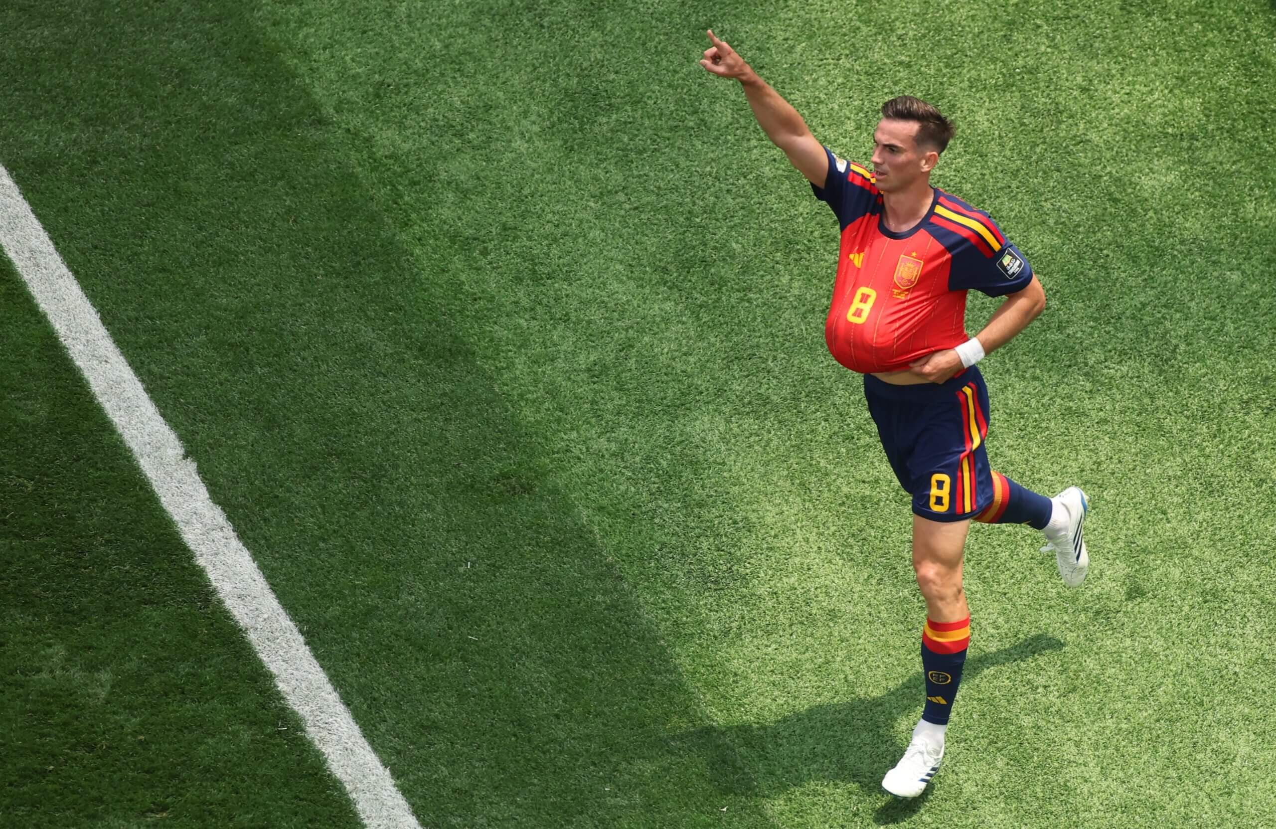 Fabian Ruiz celebrates his team's opener against Belgium with the ball up his shirt