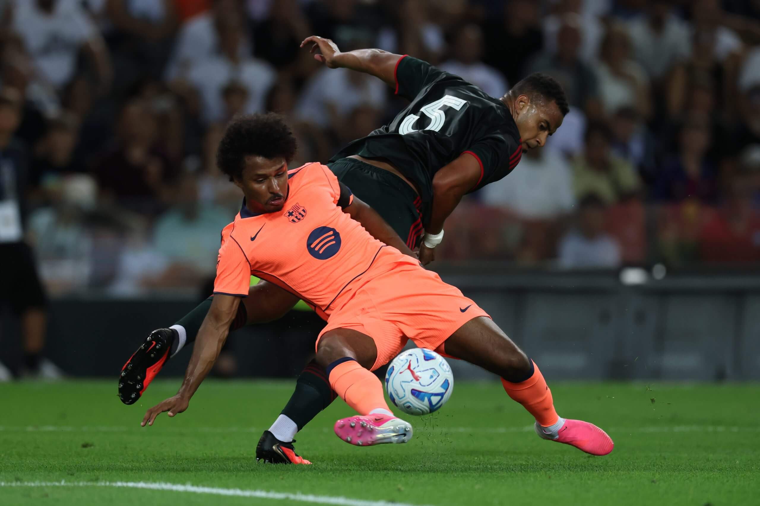 Nottingham Forest defender Murillo looks at the ball as he pressurises Barcelona's Karim Adeyemi