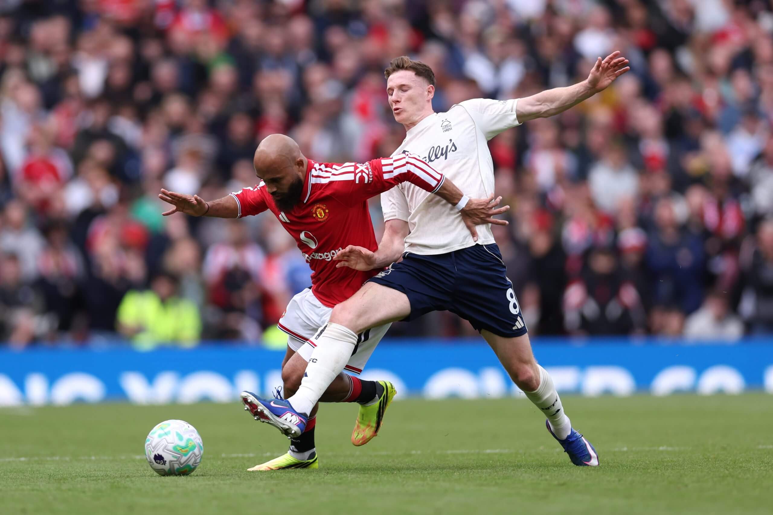 Elliot Anderson challenges Manchester United's Bryan Mbeumo during a Premier League game