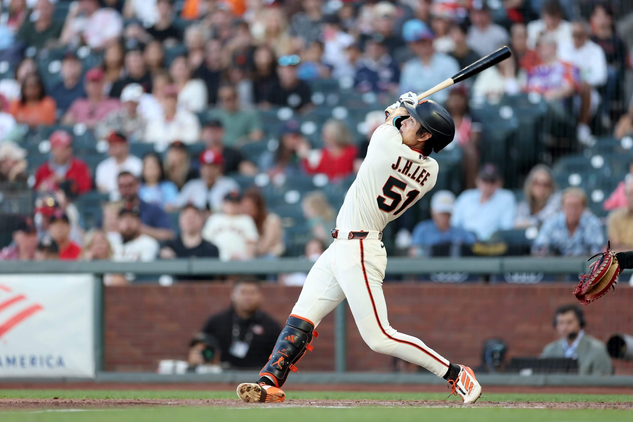 Jung Hoo Lee follows through on a left-handed swing at Oracle Park.